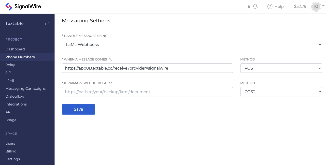 A screenshot of the Messaging Settings section of the Phone Numbers tab of a SignalWire space. The phone number is set to handle messages using LaML Webhooks, and the 'When a Message Comes In' field is set to the provided Textable URL.